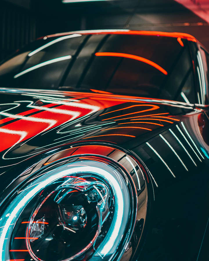 Front view of sports car under red and white lights